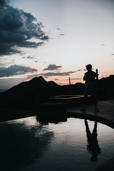 Standing in front of the swimming pool man silhouette
